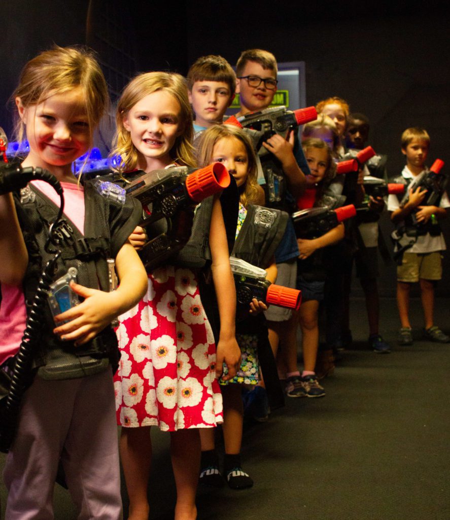 Group of kids smiling at camera at Rev'd Up Fun birthday party