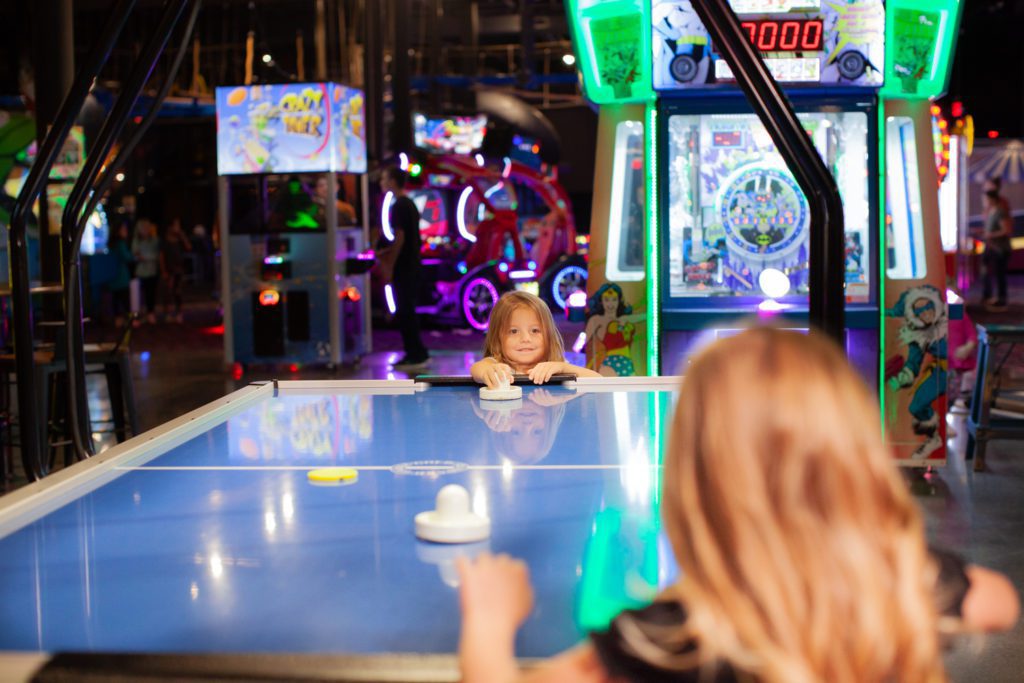 Kids playing air hockey