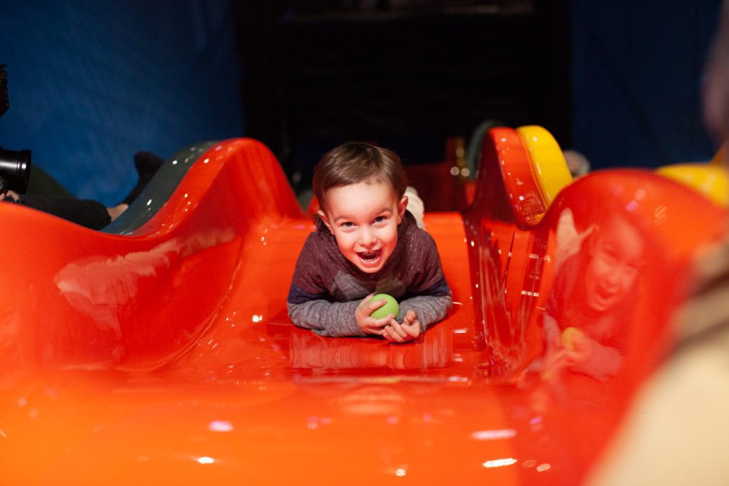 Child with ball on a slide